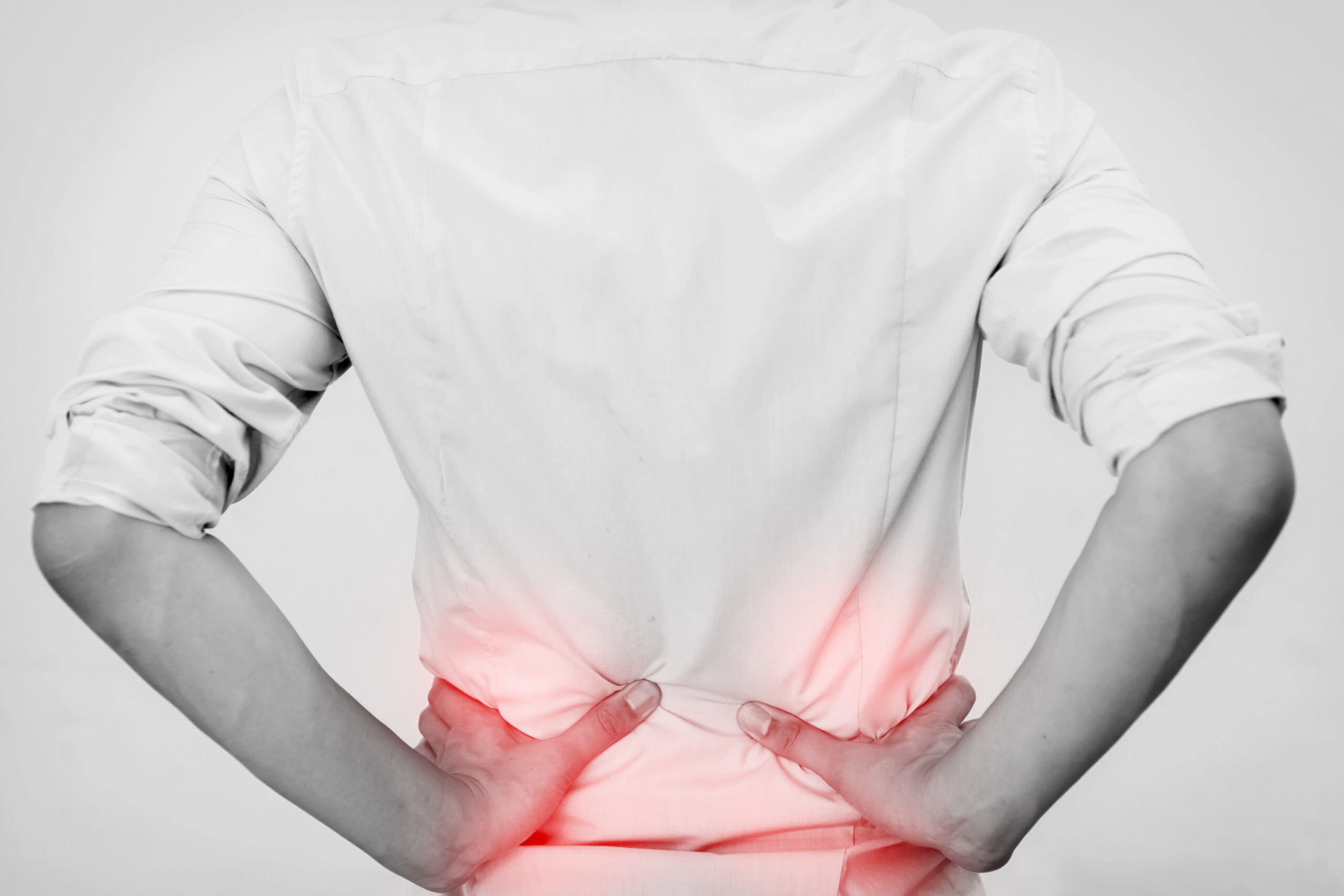 Young man in casual office shirt having hip pain